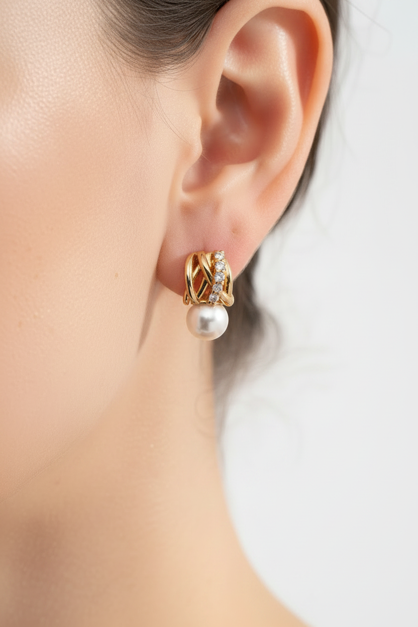 Macro close-up of 18K gold vermeil woven lattice pearl drop earring on earlobe