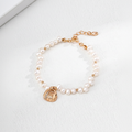 Pearl & CZ Lotus Lantern Charm Bracelet - 18K Gold on cream background