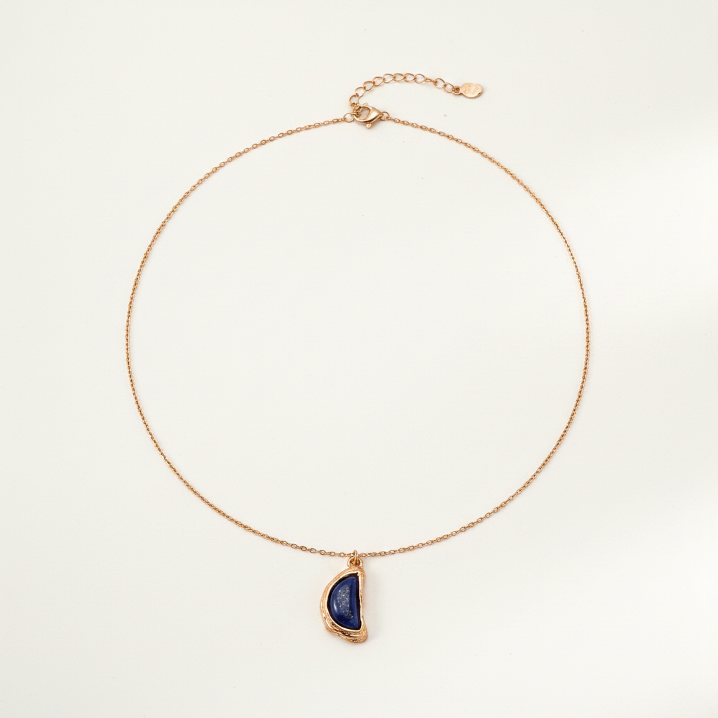 Lapis Lazuli Half-Moon Molten Frame Necklace on cream white background