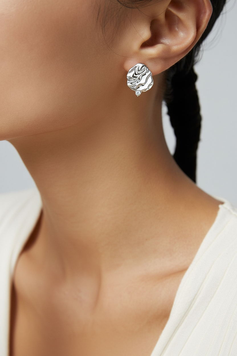Model wearing Platinum Molten Ripple Stud Earrings - close-up
